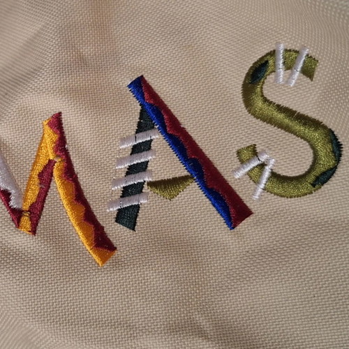 Beige fabric beach bag with colorful embroidered Bahamas lettering