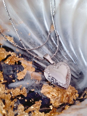 Steel heart-shaped silver locket made to order with floral details
