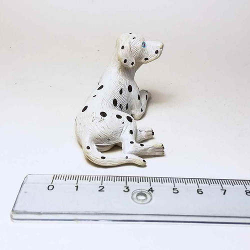 Plastic dog figure used with scratches and marks