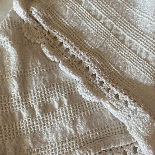 Woven cotton bedspread used with handmade lace trim