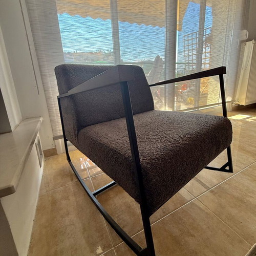 Rocking armchair with grey boucle fabric