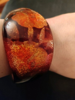 Asymmetric bracelet like new, multicolor, resin with floral and glitter design