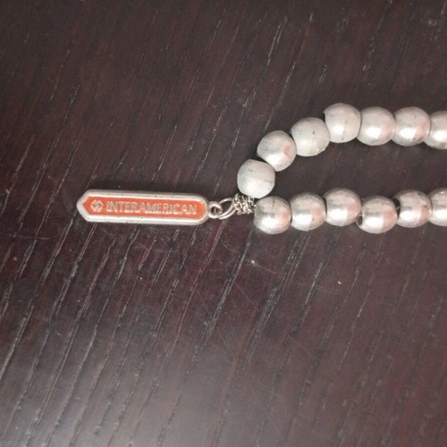Worry beads used with metal element and Interamerican logo