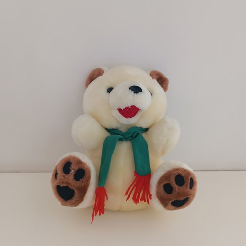 Plush teddy bear with green scarf, ecru