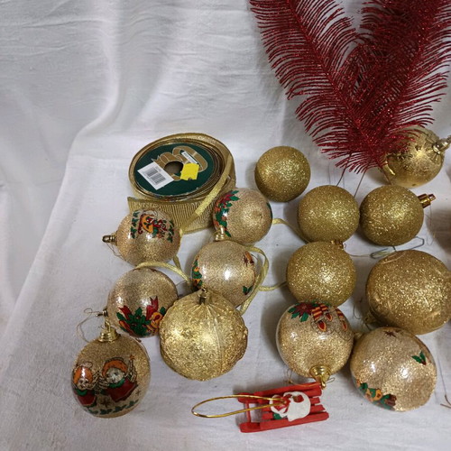 Christmas decorations like new, assorted ornaments and ribbon