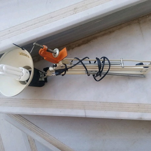 Office lamp with articulated spring and spiral clock