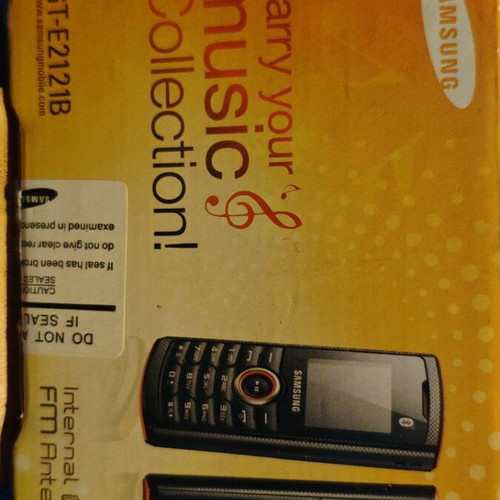 Samsung GT-E2121B mobile phone new with charger and headphones