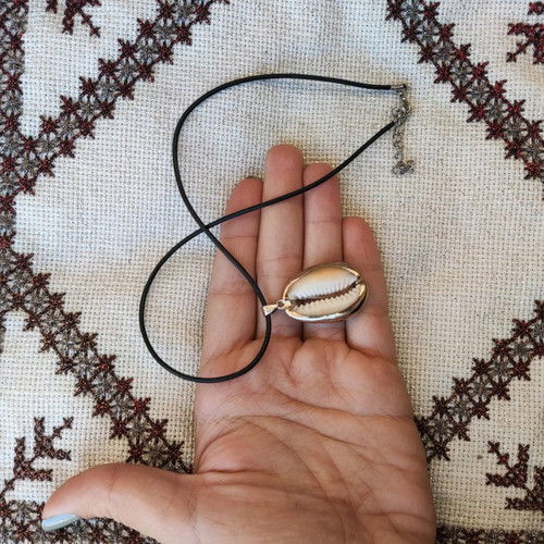 Necklace new with black cord and gold-plated shell