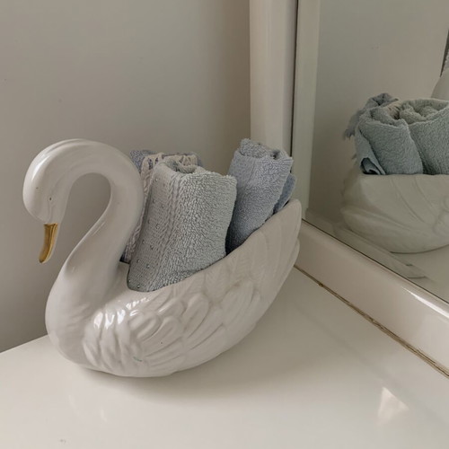 Vintage ceramic swan pair with glossy white finish and gold beak