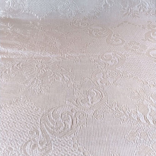 Woven quilt or throw with floral motifs, white