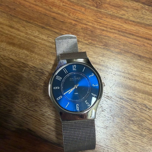 Skagen watch used with blue dial and silver bracelet