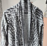 Asymmetric knitted cardigan with fringes, black and grey
