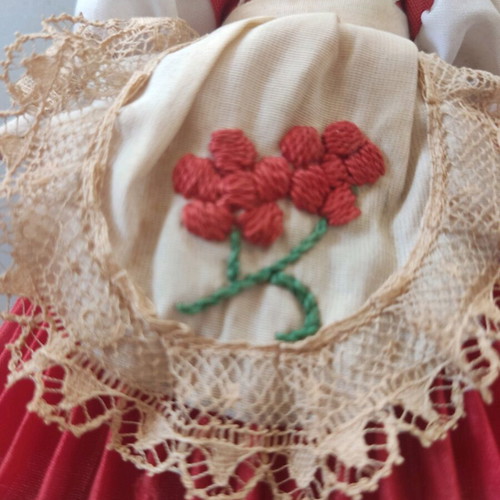 Vintage doll used with porcelain head and embroidered apron
