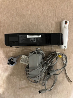 Nintendo Wii console black used with cables and controller