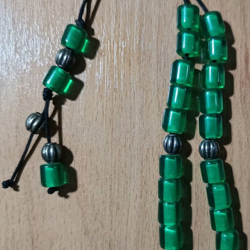 Worry beads used with green translucent beads and metal details