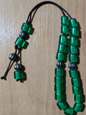 Worry beads used with green translucent beads and metal details