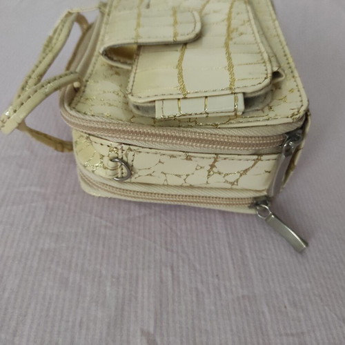 Small gold wristlet shoulder bag