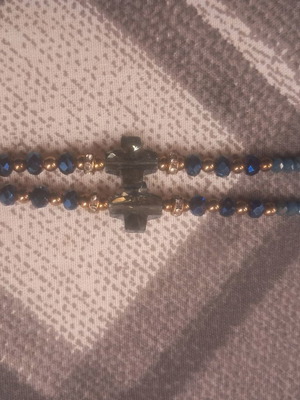 Long necklace used with blue beads and small crosses