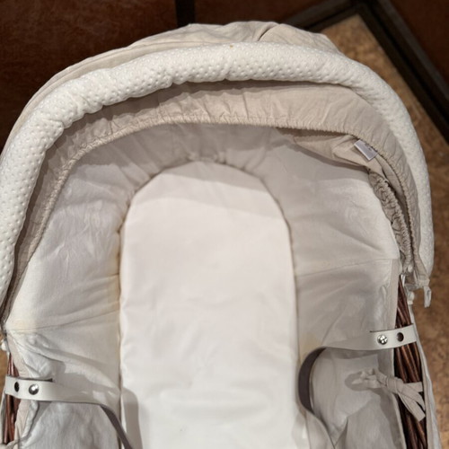 Baby bassinet with woven wicker base and hood