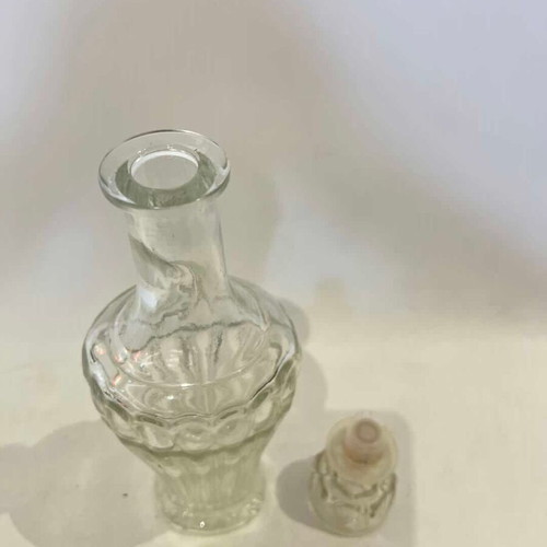 Vintage glass carafe with embossed designs used