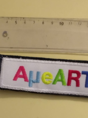 Keychain like new, multicolored fabric with embroidered logo