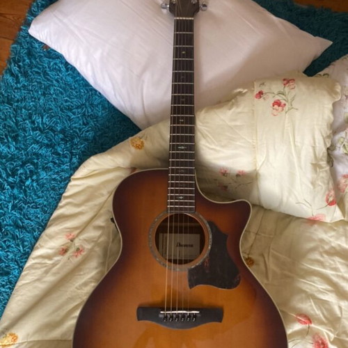 Ibanez folk acoustic guitar with crack on table