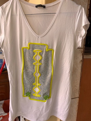 Women's white short-sleeve blouse with razor blade design, size S used