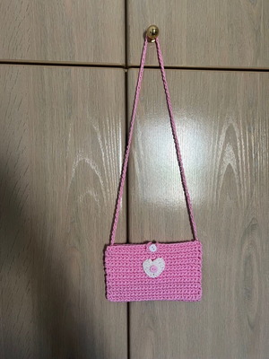 Children's pink knitted bag with heart and button