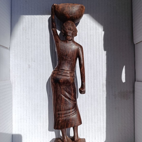 Rosewood figure of woman with basket from Bali, like new