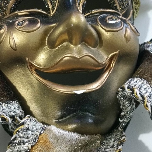 Decorative mask used, wall hanging, black with wear