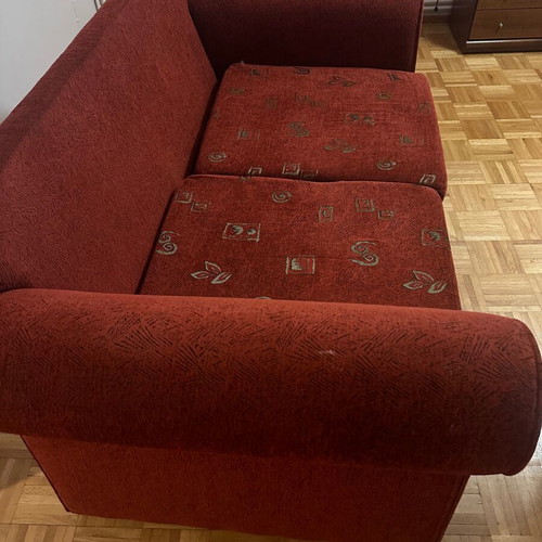 Two-seater sofa used red in good condition