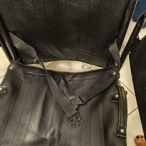 Manual wheelchair used with rear wheel brakes and belt