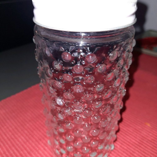Large drink glass with hole for straw
