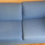 Two-seater sofa used without two back cushions