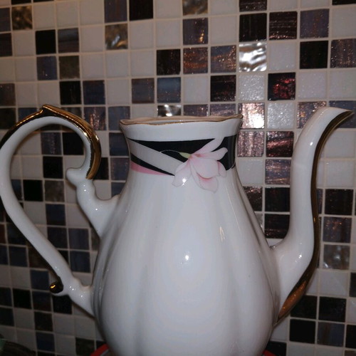 Vintage teapot used with gold details, missing lid