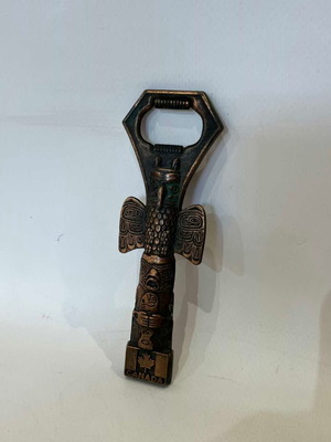Vintage copper bottle opener from Canada with Thunderbird totem used