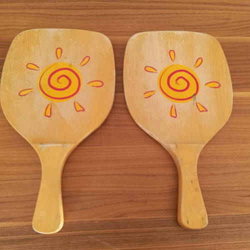 Wooden beach rackets with sun design used, pair
