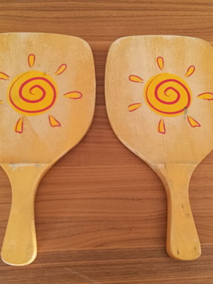 Wooden beach rackets with sun design used, pair