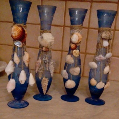 Glass vase decorated with natural shells like new