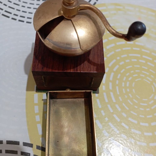 Vintage miniature manual coffee grinder with wooden body and brass hopper