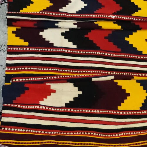 Woven rug used with geometric motifs and fringes