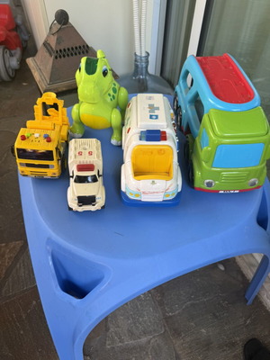 Various toys including vehicles and dinosaur