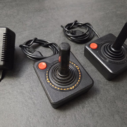Atari 2600 VCS Woody console used with two joysticks and Demon Attack game