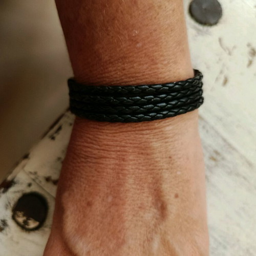 Black leather-type bracelet with silver elements used
