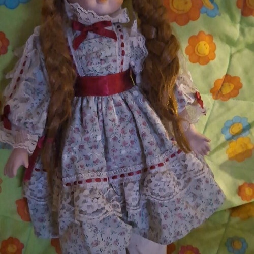 Decorative doll with porcelain head and fabric body like new