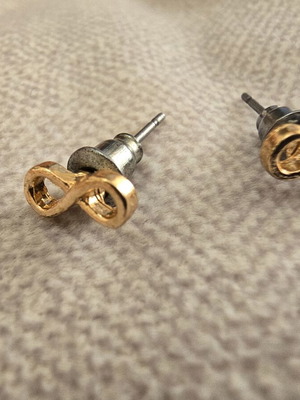 Infinity stud earrings in gold tone