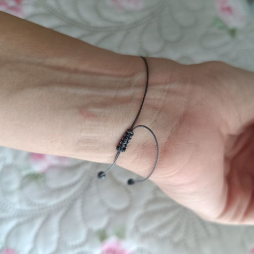 Bracelet with adjustable cord, like new, gray and gold