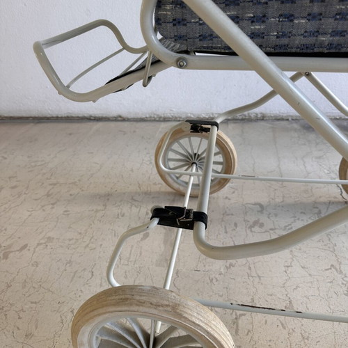 Vintage baby stroller with classic check fabric and metal frame