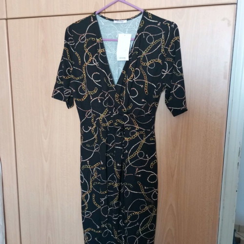 Black dress new with gold drape and pointed hem