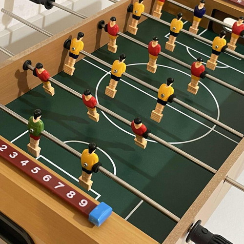 Children's foosball table used without balls and missing one handle